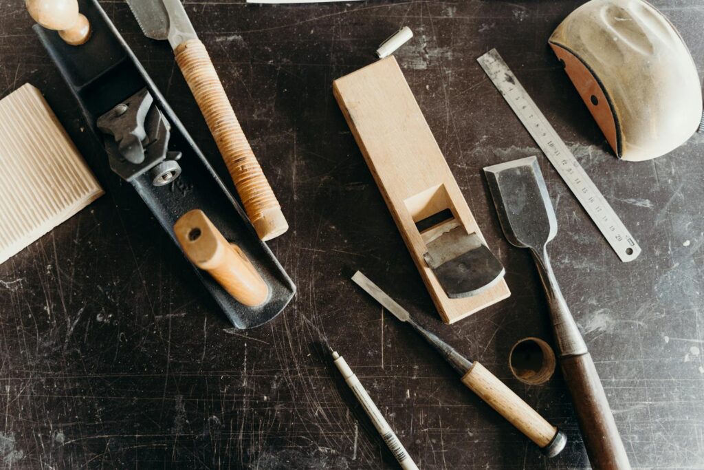 A collection of woodworking tools on a workshop table, showcasing craftsmanship essentials.